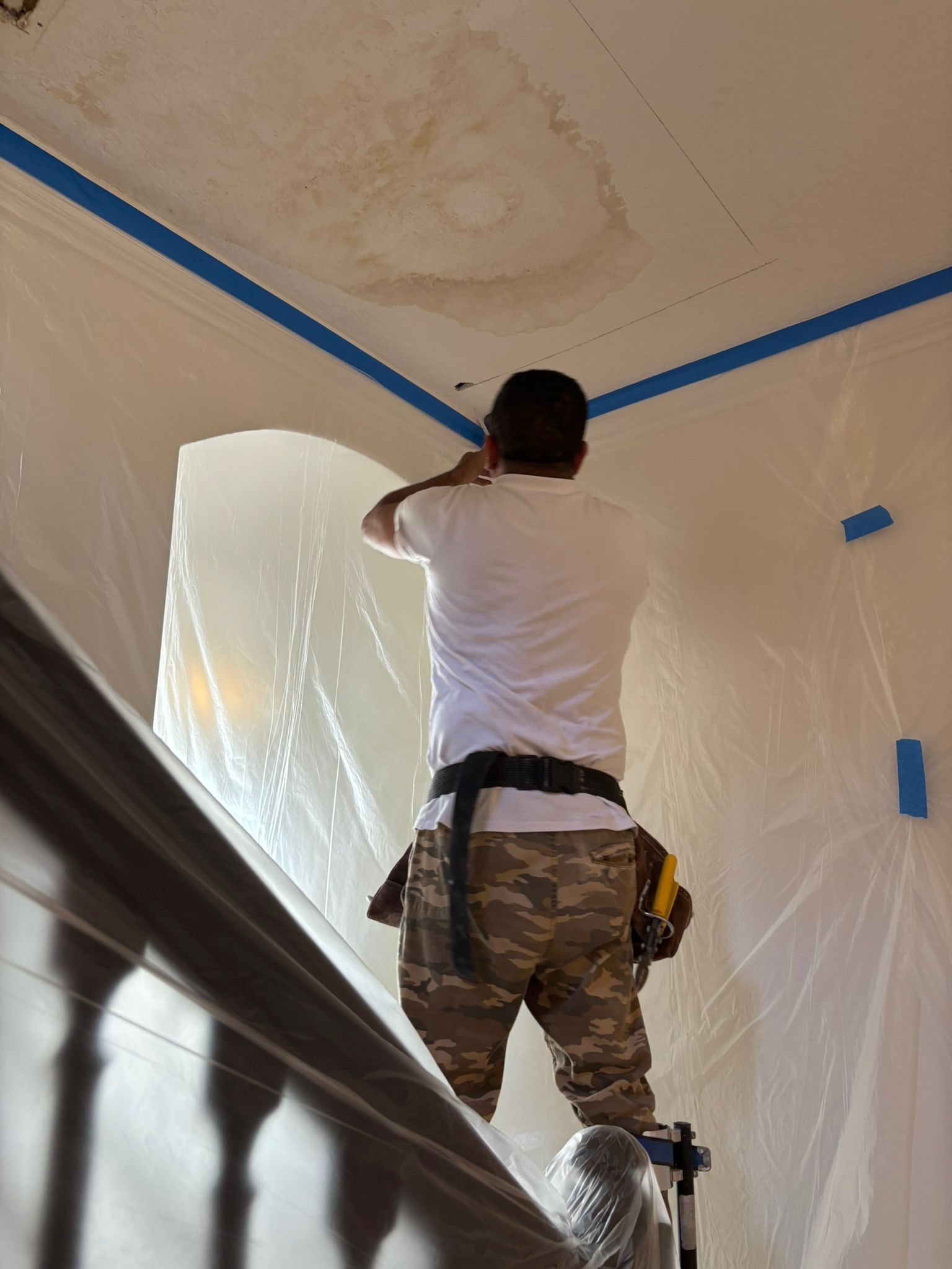Drywall water damage repair on stairwell ceiling. Third Coat Orlando