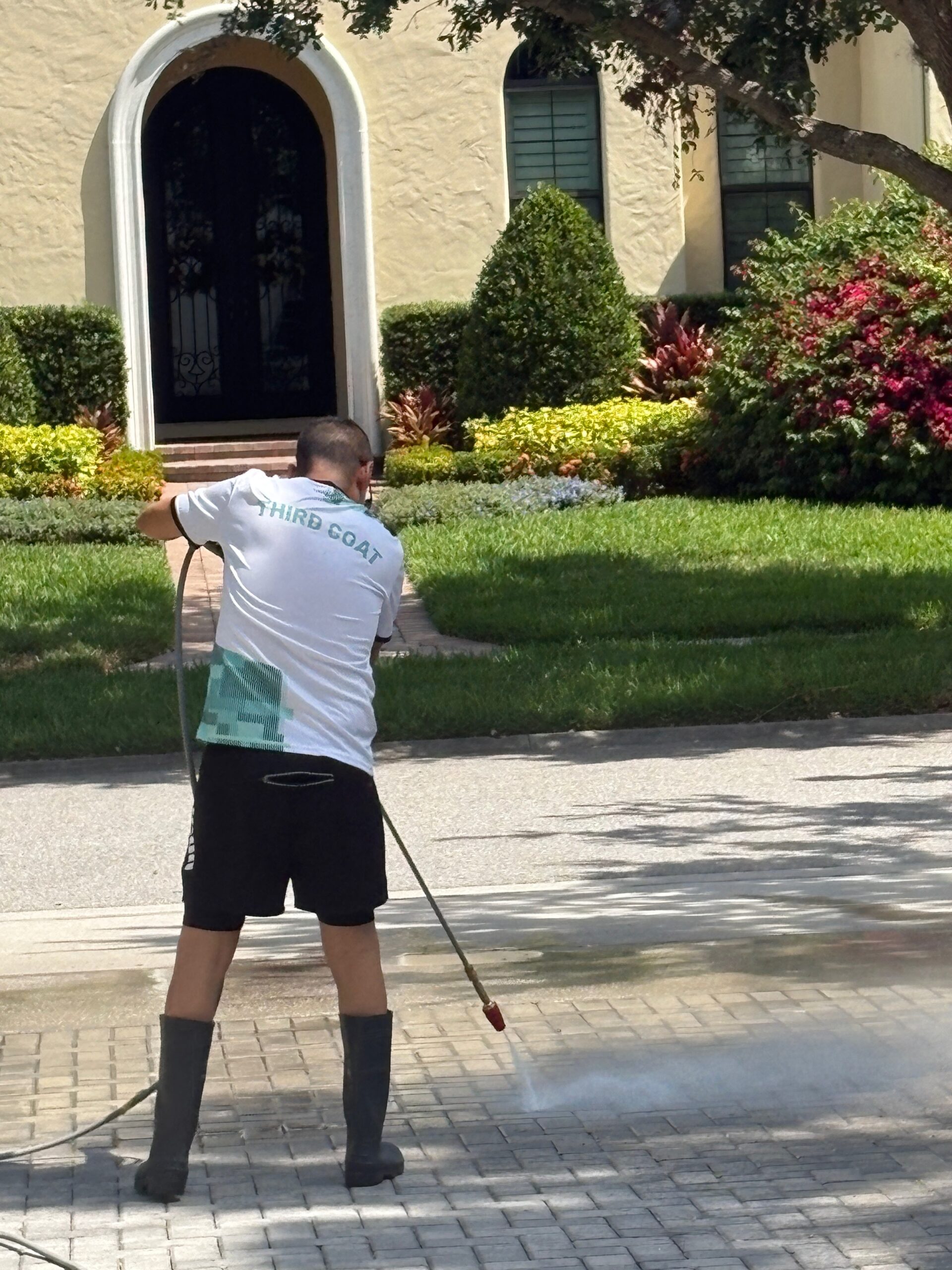 Driveway pre-treatment with cleaning solution by Third Coat. Central Florida
