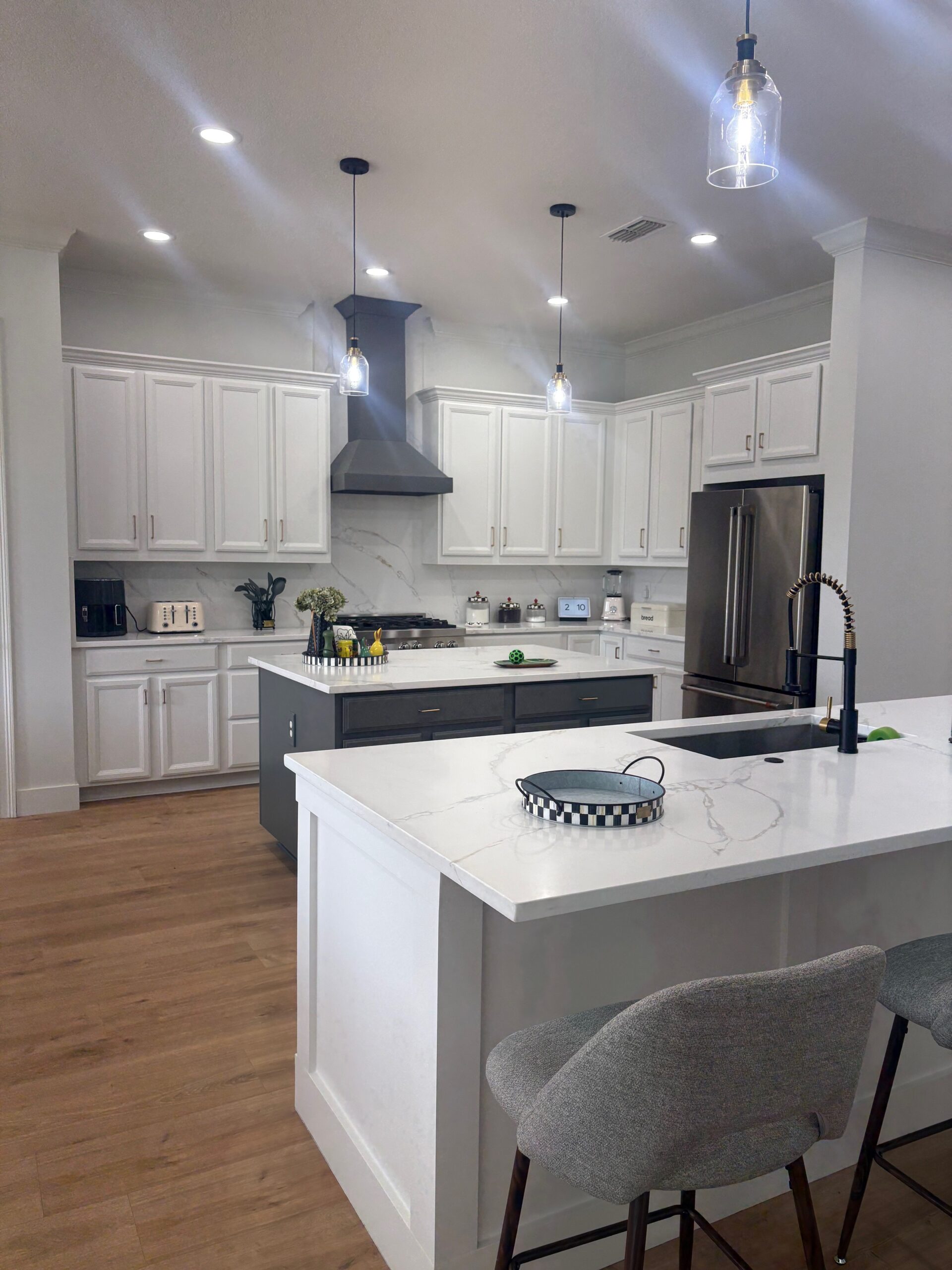 Open concept kitchen refreshing with new hood, island and repainted cabinets. Third Coat Orlando