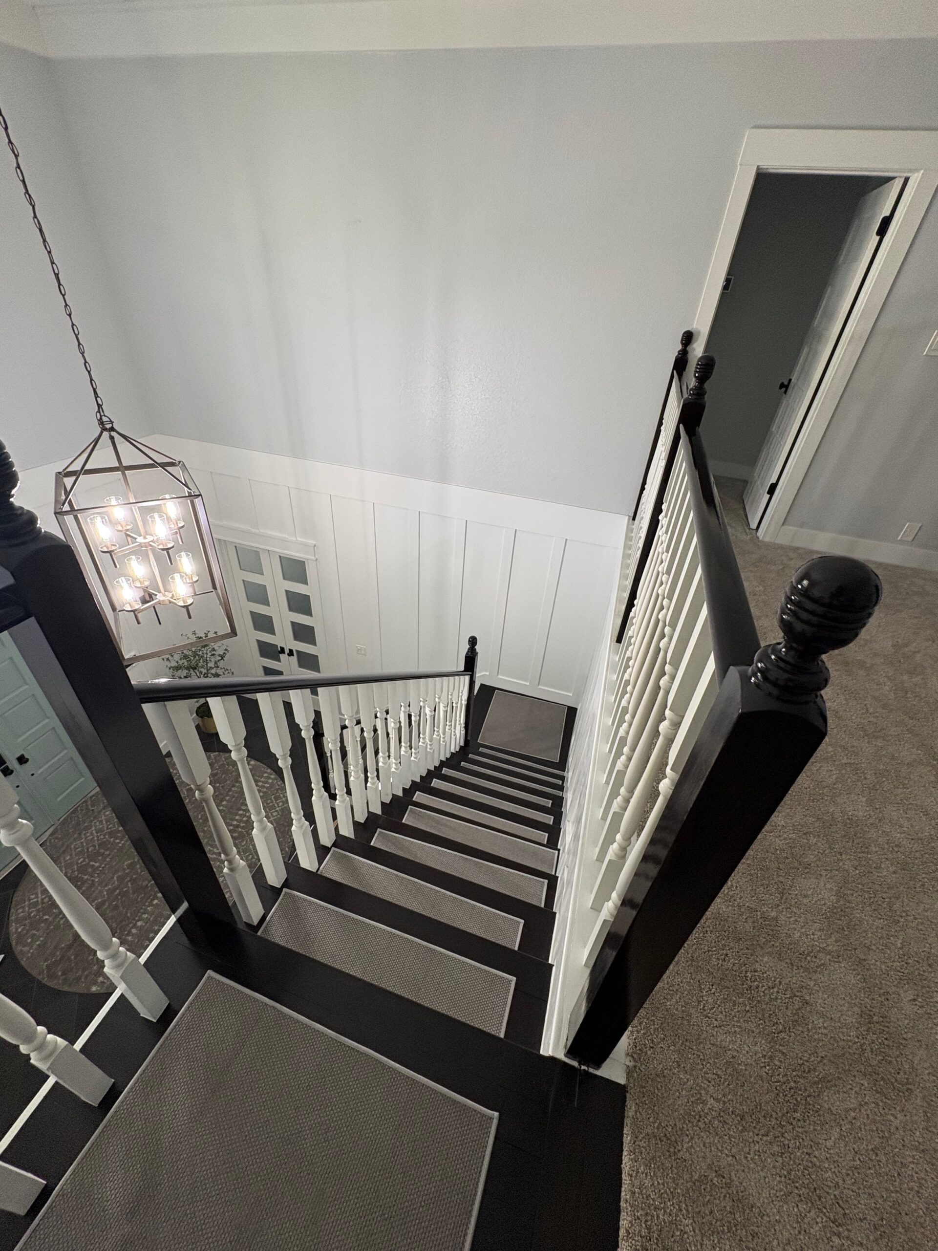 Premium wood staircase staining with dark stained handrails and treads. Third Coat Orlando